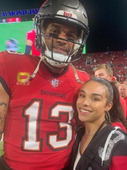 Ashli Dotson with her husband Mike Evans during the game